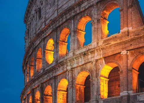 Landscape Image Of A Section Of The Colloseum in Rome In The Evening, Showing Two Floors Or Arches Backlit