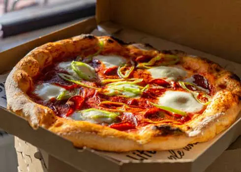 Neapolitan Style Pizza In A Brown Cardboard Takeaway Box